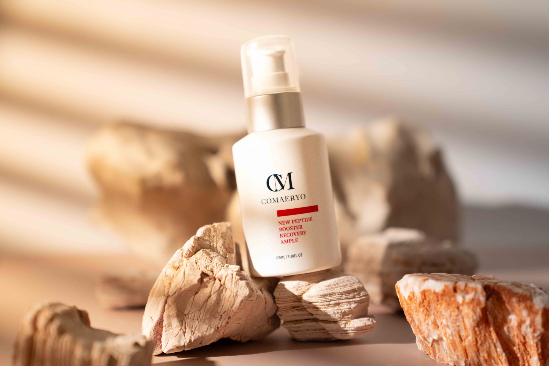 White pump bottle in a warm stone setting.