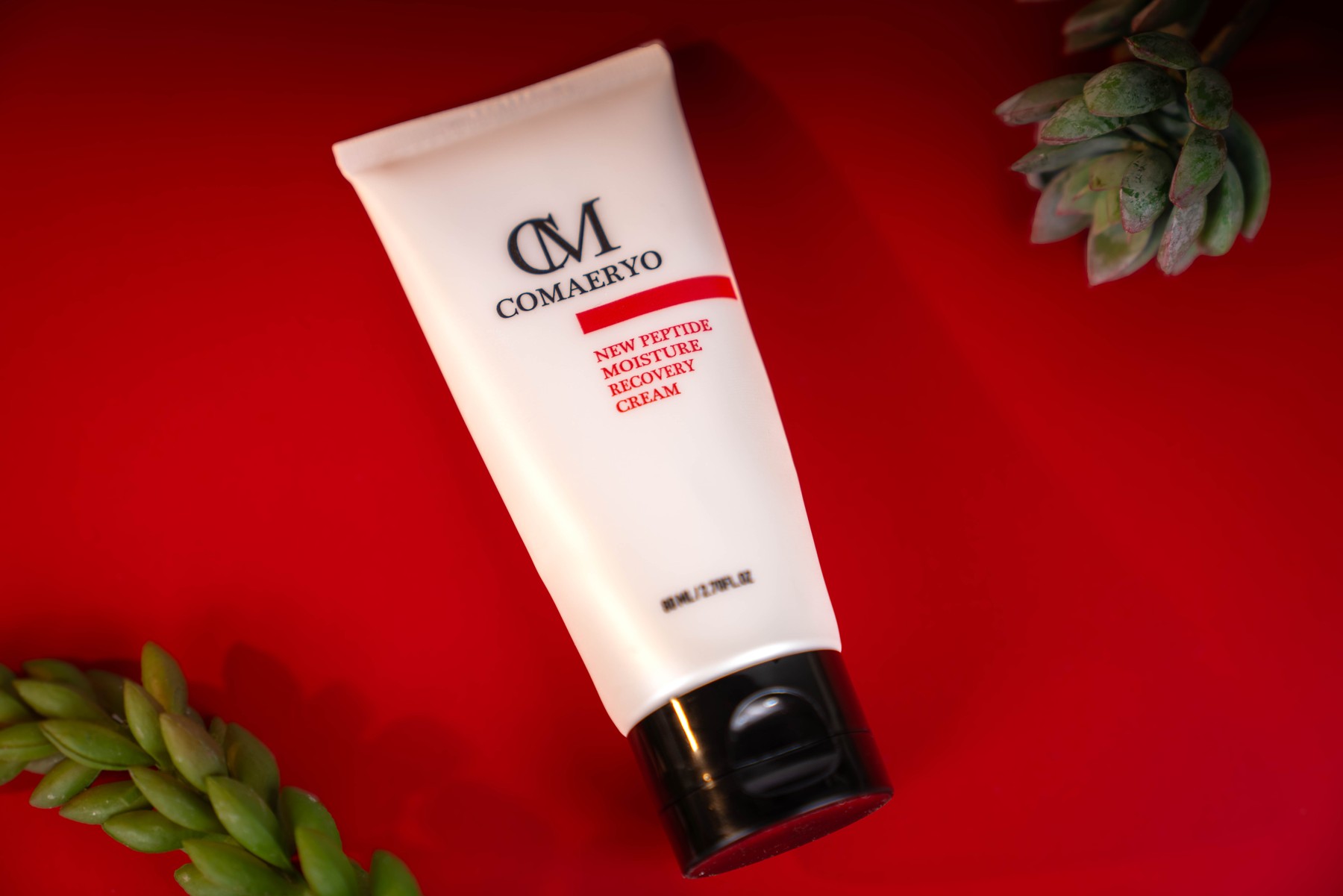 White tube and foliage on a red set.